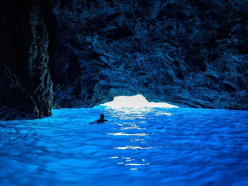 The Blue Grotto lit from below, the water glowing where the daylight comes through the entrance