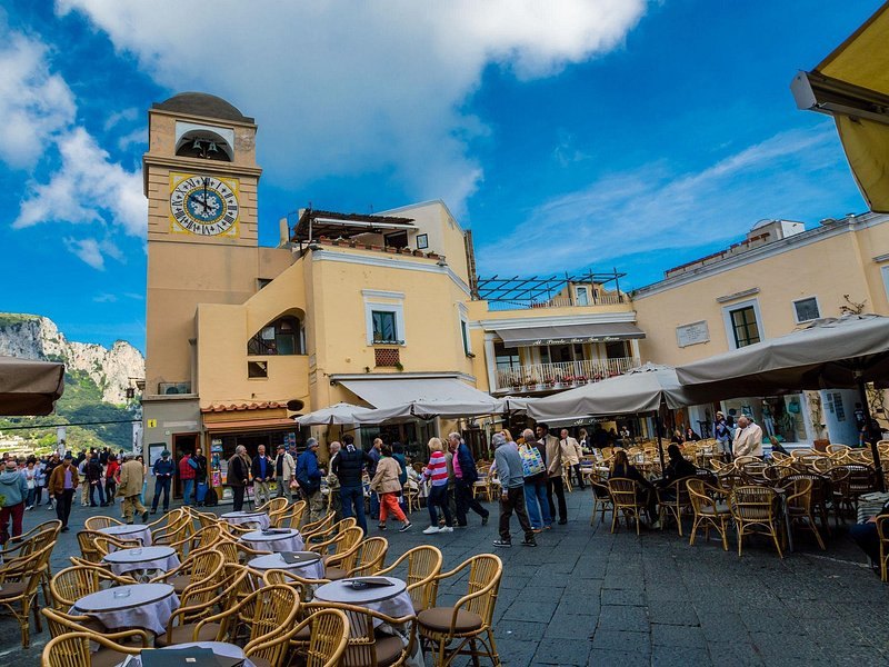 The clock tower and café tables of the Piazzetta in Capri town